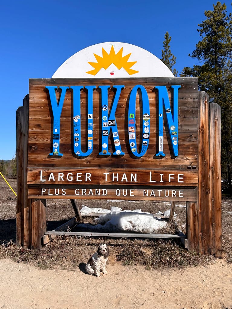 Mitzi in front of Yukon sign
